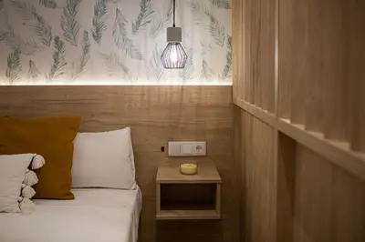 a bedroom with a bed with a night stand and a light at FLORIT FLATS - Valencia Port Rooms II in Valencia