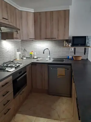 a kitchen with a sink and a stove at APPARTEMENT VUE MER 40 METRES DE LA PLAGE in Cullera