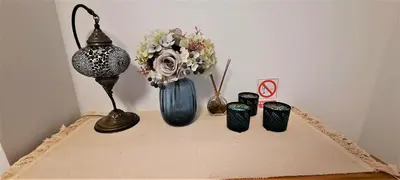 a table with a group of vases and flowers on it at Apartamento Peonia 1 in Canet de Berenguer