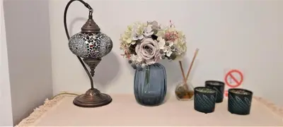 a table with a vase with flowers and other items at Apartamento Peonia 1 in Canet de Berenguer