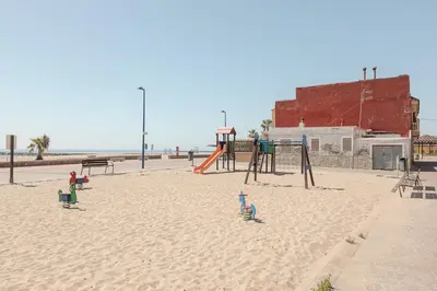 a playground in the sand on the beach at Marsalada - Ground floor front line beach apartment in Playa de Mar