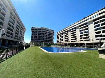 a view of two tall buildings and a swimming pool at M & B Beach Apartment in Valencia