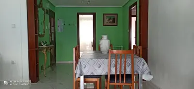 a green dining room with a table and chairs at Saint Germain 2C in Cullera