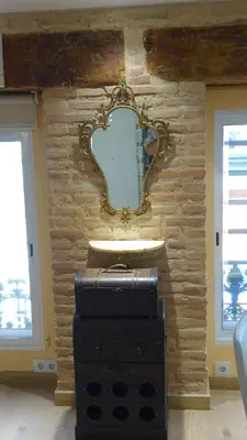 a stone wall with a mirror and a sink at Lepanto Centro Valencia1 in Valencia