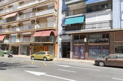 a city street with cars parked in front of buildings at Solimar, 5-24 in Cullera