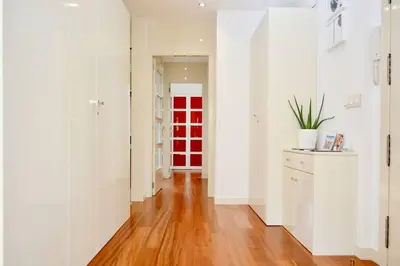 a hallway with white walls and a red door at Hola Valencia - Holiday Apartments in Valencia