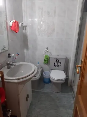a bathroom with a toilet and a sink at habitación pequeña en piso compartido con 2 adultos in Valencia