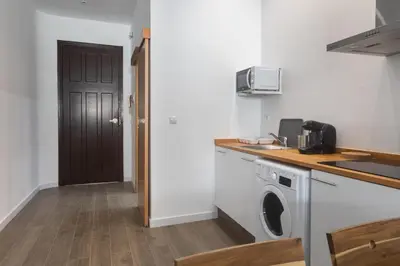 a kitchen with a washing machine and a door at Exclusivos Lofts en Plaza del Ayuntamiento in Valencia
