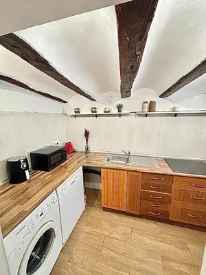 a large kitchen with a washer and dryer in it at EL RINCÓN deMANUELA in Requena