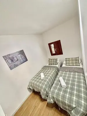 two beds sitting next to each other in a room at EL RINCÓN deMANUELA in Requena