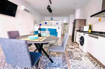 a dining room with a table and chairs in a kitchen at Arenas beach in Valencia
