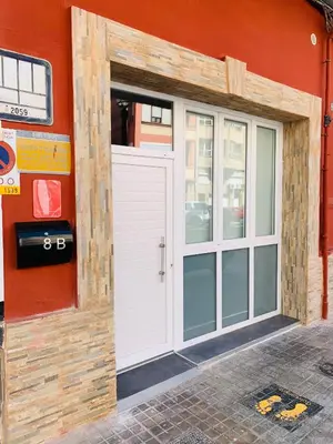 a white door on the side of a building at Arenas beach in Valencia