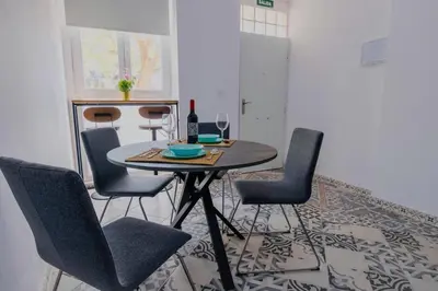 a dining room with a table and four chairs at Arenas beach 3 in Valencia