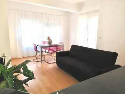 a living room with a black couch and a table at Aitana in Fortaleny