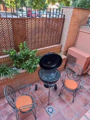 a patio with two chairs and a grill at Casa MUNDOVALENCIA in Valencia