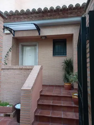a brick house with a staircase leading to the door at Casa MUNDOVALENCIA in Valencia