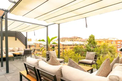 a patio with couches and chairs on a roof at Valencia Luxury - Sea Port II in Valencia