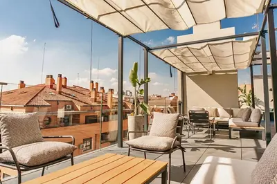 a patio with chairs and a table on a balcony at Valencia Luxury - Sea Port II in Valencia
