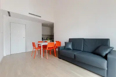 a living room with a couch and a table and chairs at Apartamentos Mercado Central in Valencia