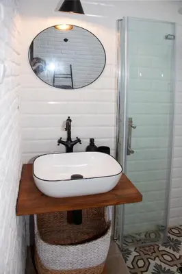 a bathroom with a white sink and a mirror at Apartamento a 400m de la playa, Puerto de Sagunto in Puerto de Sagunto