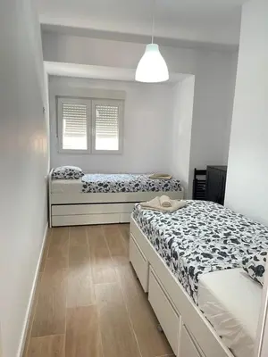 a bedroom with two beds and a window at UIM Mediterraneo Columbretes 1 Wifi in Puerto de Sagunto