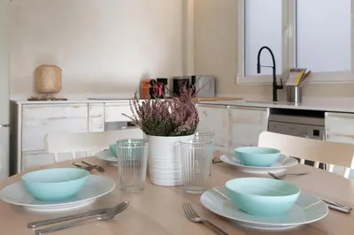 a table with plates and bowls on it in a kitchen at Your home at Valencia, Marina Real in Valencia