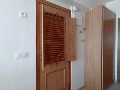 a wooden door in the corner of a room at Apartamento en El Prado in Cullera