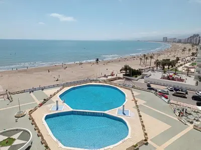 a view of a beach and a swimming pool at Apartamento en El Prado in Cullera