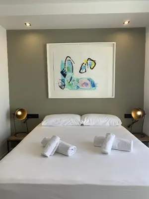 a white bed with three towels on top of it at VLC HOST- Eixarchs in Valencia
