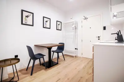 a kitchen and dining room with a table and chairs at VLC HOST- Eixarchs in Valencia