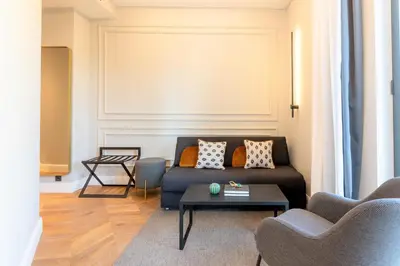 a living room with a couch and a table at L&H Gran Vía Valencia in Valencia
