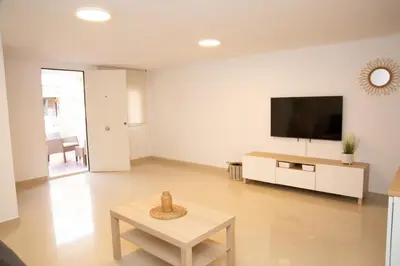 a living room with a flat screen tv on a wall at Summer Beach House in Puebla de Farnals