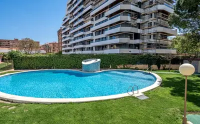 a swimming pool in front of a apartment building at Palau de Vic in Valencia