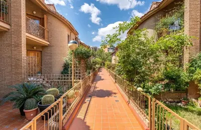 a walkway in front of a building with plants at Palau de Vic in Valencia