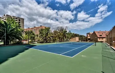 a tennis court with a tennis court at Palau de Vic in Valencia