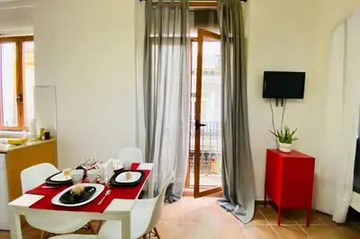 a dining room with a red table and white chairs at Acogedor loft en centro histórico in Valencia