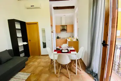 a kitchen and a table with white chairs in a room at Acogedor loft en centro histórico in Valencia
