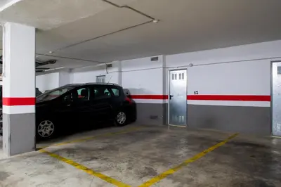 a parking garage with a car parked in it at FLORIT FLATS - The Malvarrosa Beach Apartment & Free Parking in Valencia