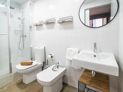 a bathroom with a toilet and a sink and a mirror at MD Vitoria City Center in Valencia