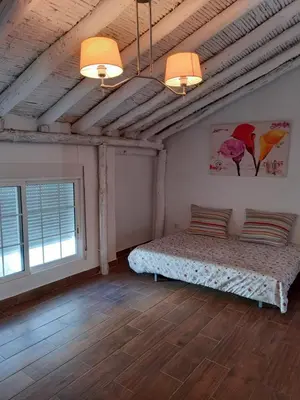 a room with a bed and two windows in it at La Gata Mala in Navarrés