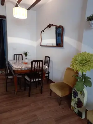a dining room with a table and chairs and a mirror at La Gata Mala in Navarrés