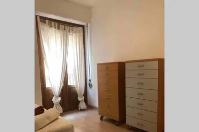 a bedroom with a dresser and a window at Acogedor apartamento en Ruzafa-centro in Valencia