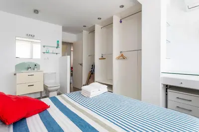 a bedroom with a bed with a blue and white stripes at Fantástico Apartamento en Primerísima Línea Playa in La Torre