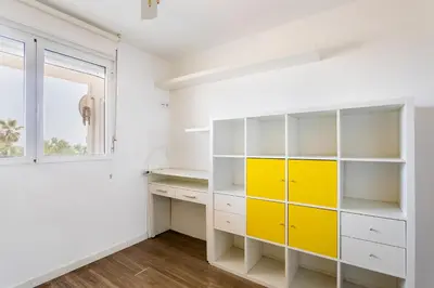 a room with white shelves and a window at Fantástico Apartamento en Primerísima Línea Playa in La Torre