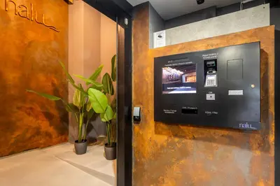 a door with a pay meter on a wall with plants at NALU Valencia Boutique Rooms in Valencia