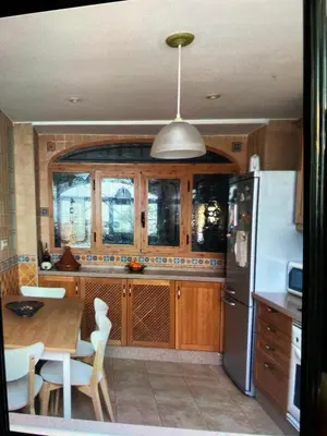 a kitchen with a table and a refrigerator at Casa de Pueblo en Navarres in Navarrés