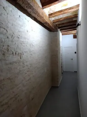 an empty room with a brick wall and a white door at SERRANO Home in Valencia
