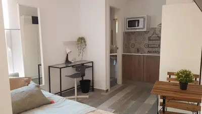 a living room with a bed and a kitchen at SERRANO Home in Valencia