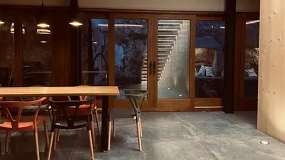 a wooden table and chairs in front of a window at Casa Rural La Cabrentà in Estubeny