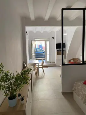 a living room with a table and a mirror at Loft Cabanyal in Valencia